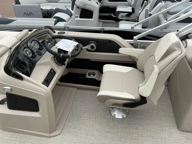 Slide: The Image of 2025 Avalon LSZ 23 Quad Lounger boat interior with steering console and luxurious seating. - 4