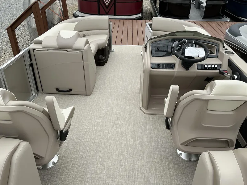 Slide: The Image of 2025 Avalon LSZ 23 Quad Lounger interior with beige seating and modern helm. - 8
