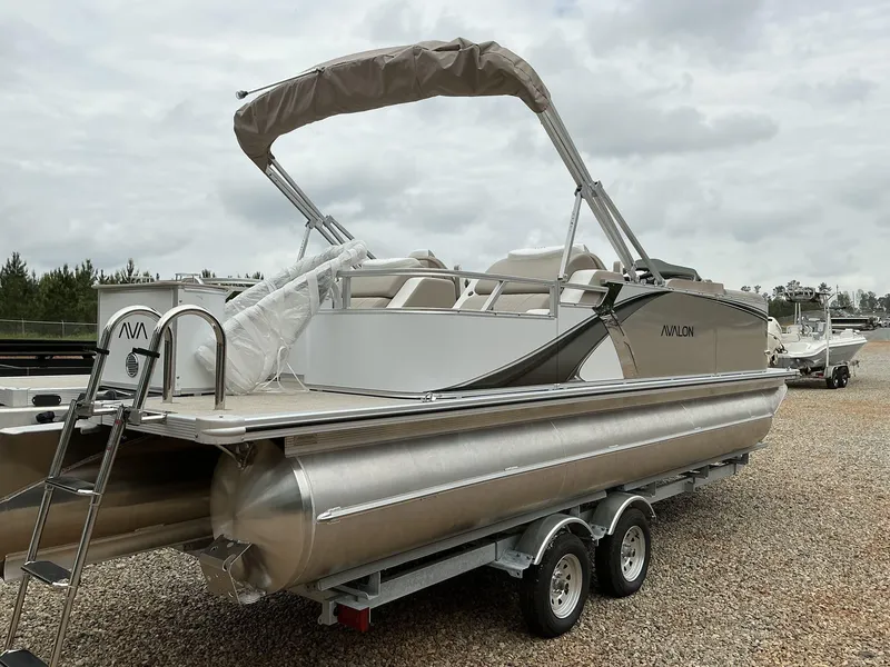 Slide: The Image of 2025 Avalon LSZ 23 Rear Lounger pontoon boat on trailer, outdoor setting. - 12