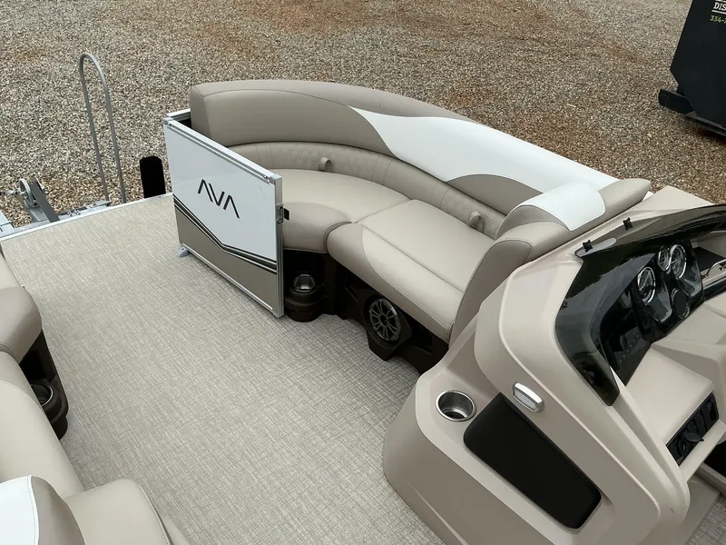 Slide: The Image of 2025 Avalon LSZ 23 Rear Lounger boat interior with beige seating and modern dashboard. - 5
