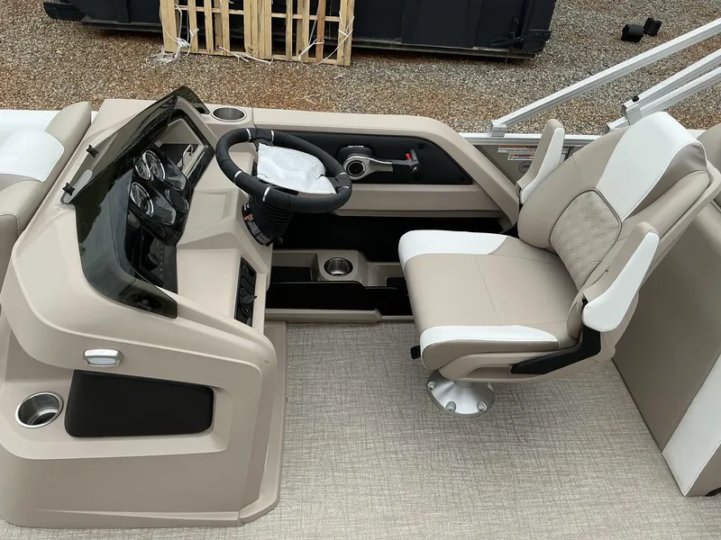 Slide: The Image of 2025 Avalon LSZ 23 Rear Lounger boat interior with steering console and captain's chair. - 6