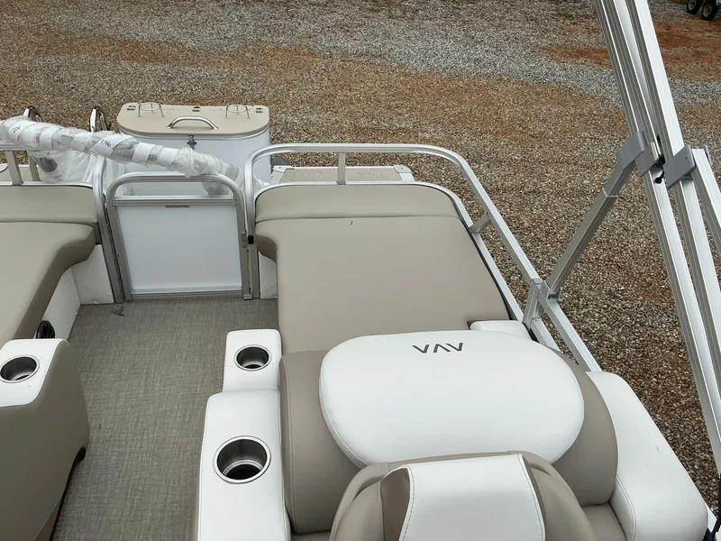 Slide: The Image of 2025 Avalon LSZ 23 Rear Lounger boat interior with beige seating and cup holders. - 7