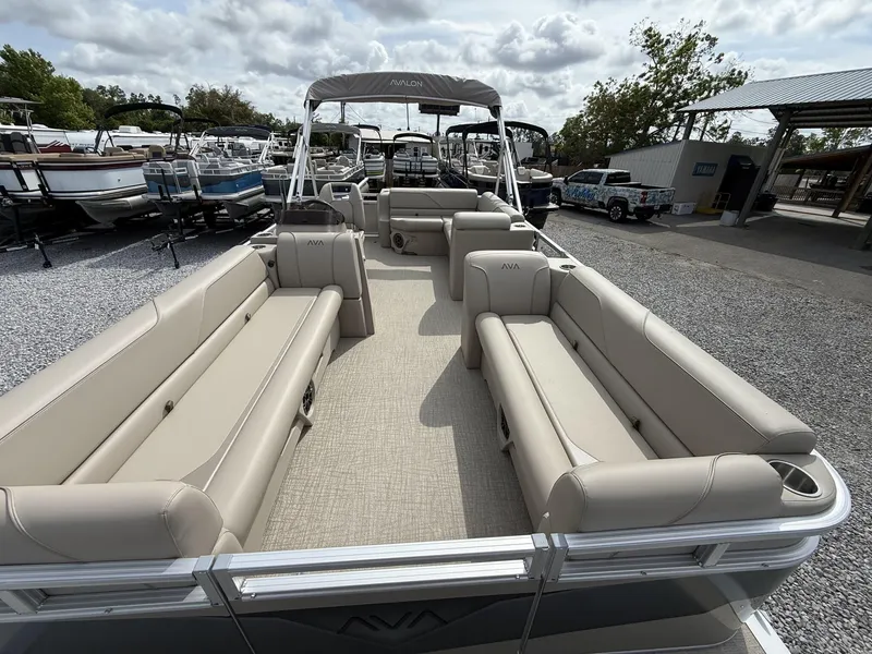 Slide: The Image of 2025 Avalon Venture 21 CRUISE pontoon boat with spacious seating and canopy, parked outdoors. - 3