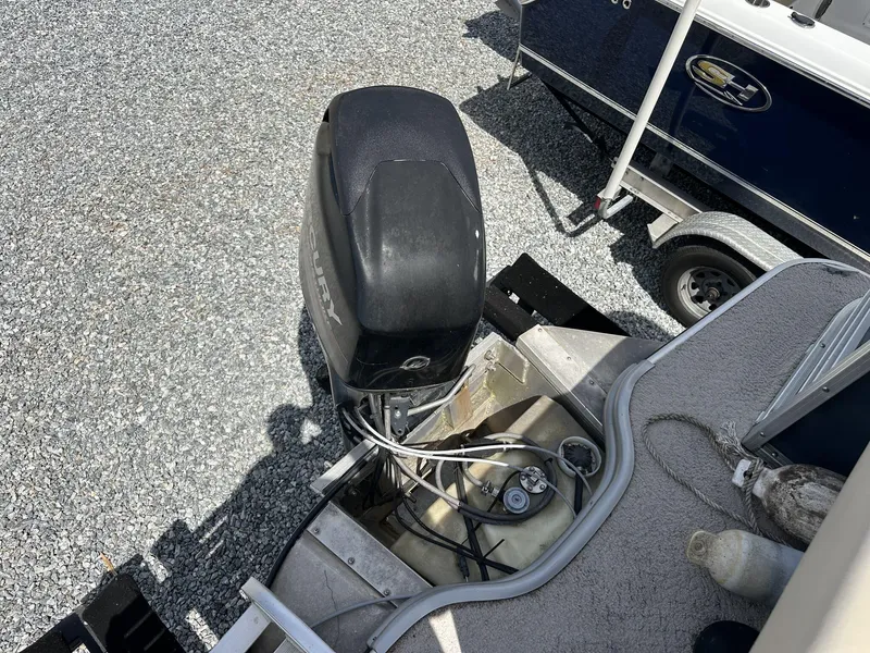 Slide: The Image of 2015 Lowe SS190 boat with Mercury outboard motor on gravel surface. - 12
