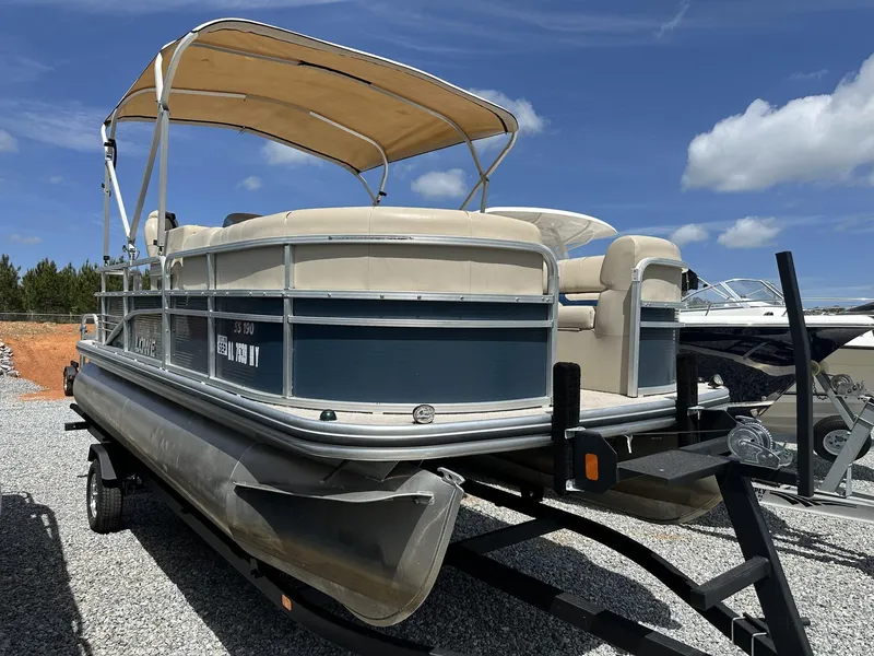 Slide: The Image of 2015 Lowe SS190 pontoon boat on trailer under clear blue sky. - 2