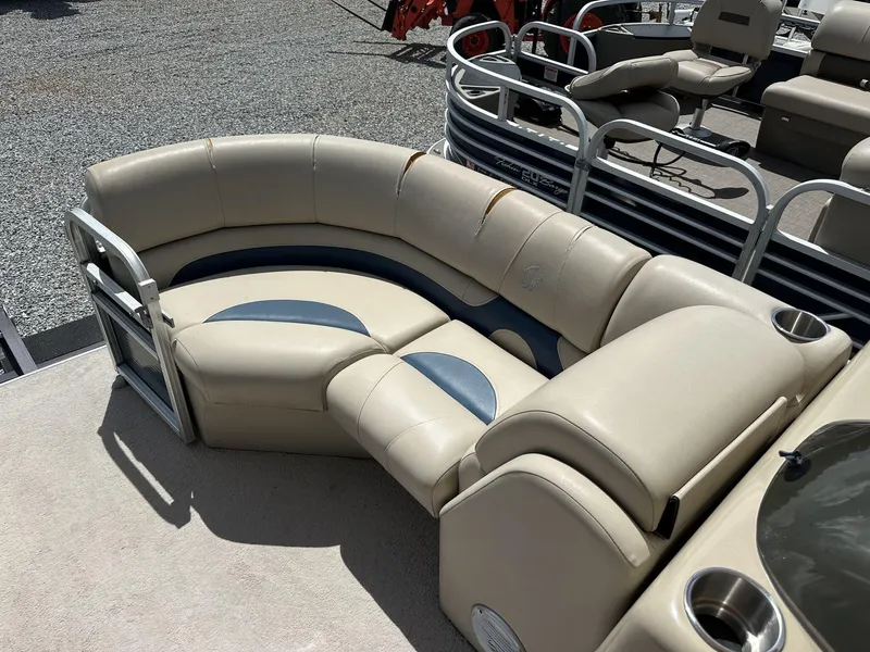 Slide: The Image of 2015 Lowe SS190 pontoon boat with beige seating and cup holders on deck. - 7