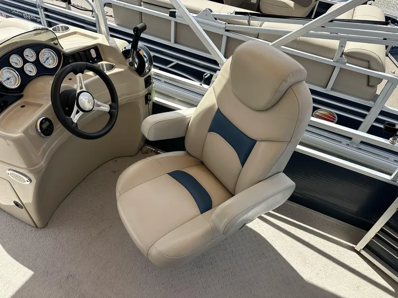Slide: The Image of Captain's chair and helm of 2015 Lowe SS190 boat, featuring beige and blue upholstery. - 9