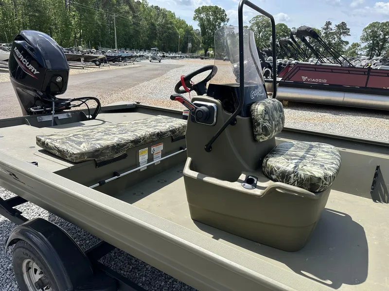 Slide: The Image of 2024 Tracker Grizzly 1860 CC boat with camo seats and Mercury outboard motor. - 4