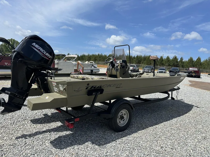 Slide: The Image of 2024 Tracker Grizzly 1860 CC boat on trailer with Mercury engine, parked outdoors. - 8