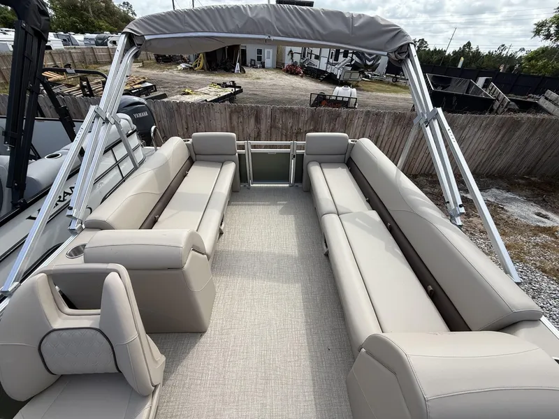 Slide: The Image of 2025 Avalon VLS 23 Quad Lounger pontoon boat with spacious seating and canopy. - 5