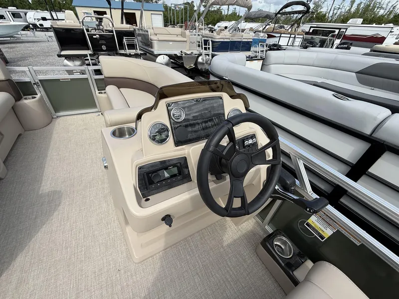 Slide: The Image of 2025 Avalon VLS 23 Quad Lounger boat interior with steering wheel and seating. - 6