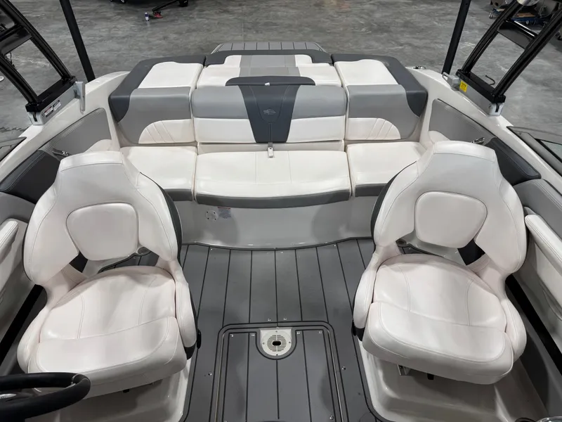 Slide: The Image of 2021 Chaparral 21 SSi boat interior with white and gray seating arrangement. - 11