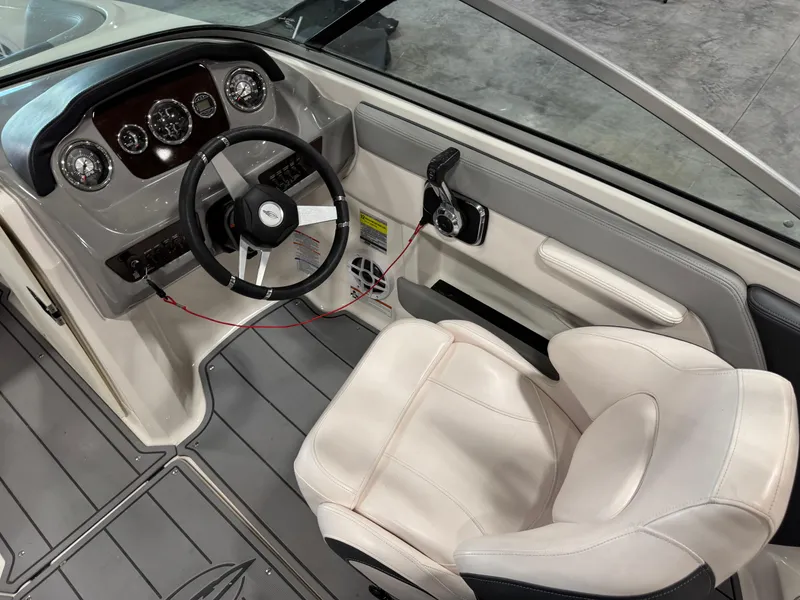 Slide: The Image of 2021 Chaparral 21 SSi boat interior with steering wheel and captain's seat. - 13