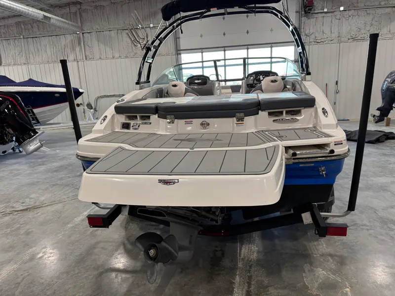 Slide: The Image of 2021 Chaparral 21 SSi boat in a showroom, rear view with swim platform. - 6