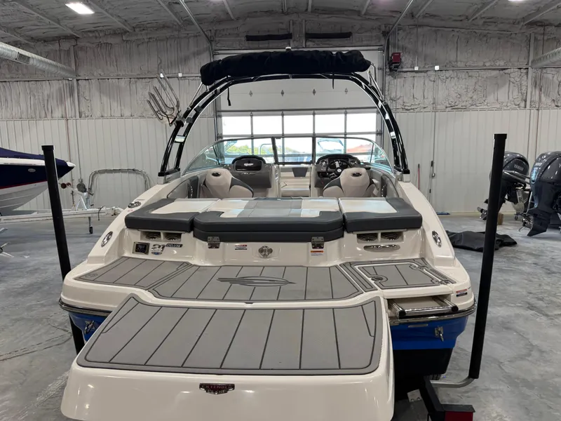 Slide: The Image of 2021 Chaparral 21 SSi boat in a garage, rear view with swim platform. - 7
