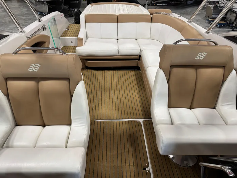 Slide: The Image of 2008 Four Winns SL 262 boat interior with tan and white seating, wood-style flooring. - 10