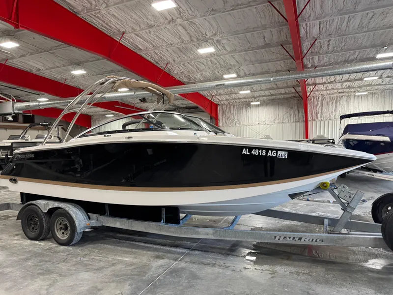 Slide: The Image of 2008 Four Winns SL 262 boat on trailer in indoor storage facility. - 2