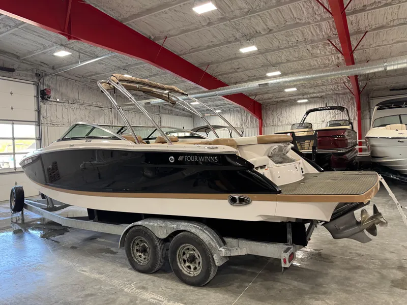 Slide: The Image of 2008 Four Winns SL 262 boat on trailer in indoor storage facility. - 3
