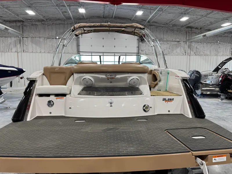 Slide: The Image of 2008 Four Winns SL 262 boat in a showroom, rear view with swim platform. - 6