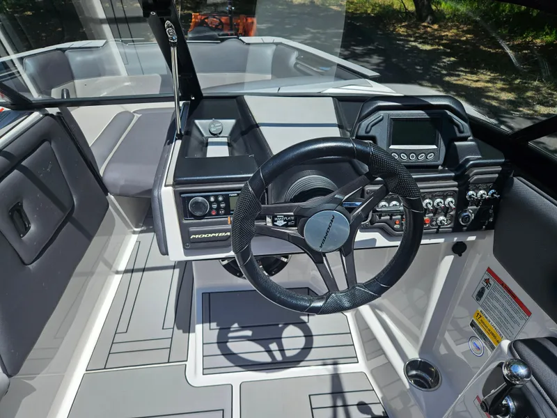 Slide: The Image of 2020 Moomba Max boat cockpit with steering wheel and control panel. - 20