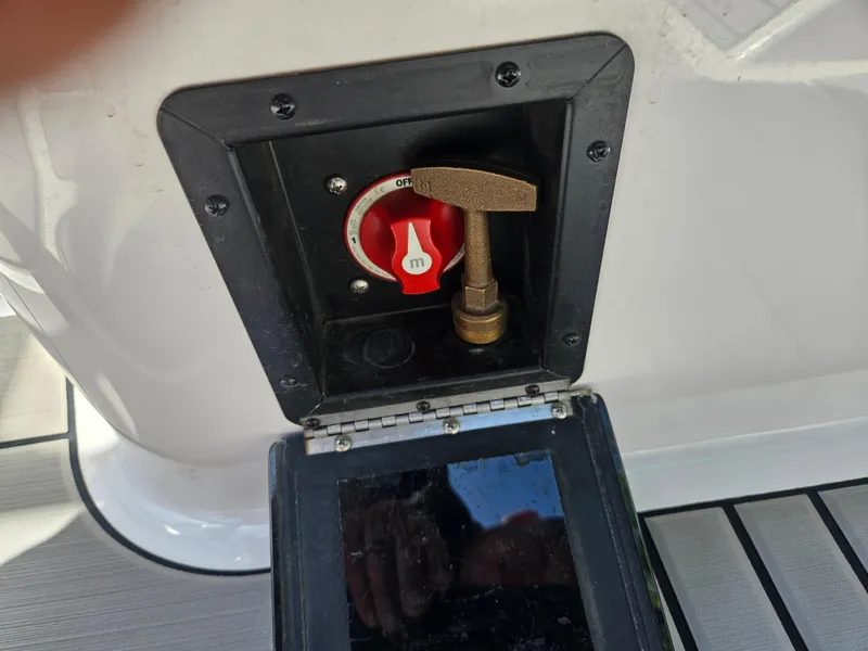 Slide: The Image of 2020 Moomba Max boat battery switch with protective cover open. - 22