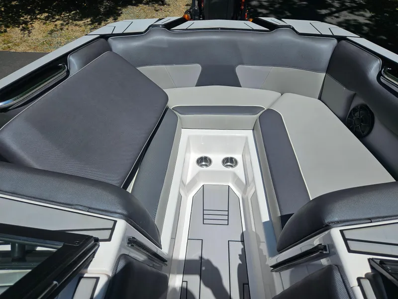 Slide: The Image of 2020 Moomba Max boat interior with gray seating and cup holders. - 25