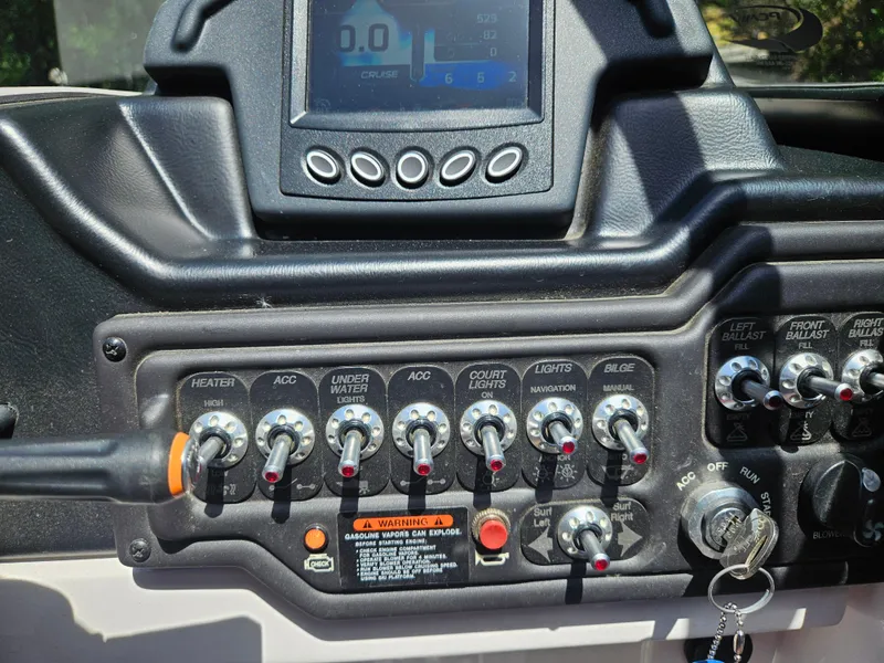 Slide: The Image of Control panel of a 2020 Moomba Max boat with various switches and display. - 29