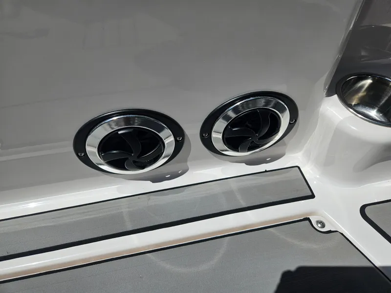 Slide: The Image of 2020 Moomba Max boat interior with dual circular air vents and cup holder. - 31