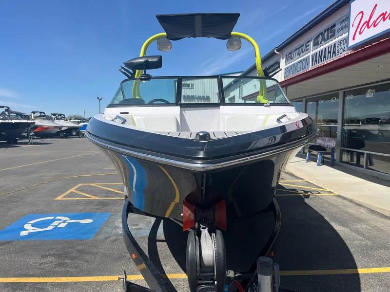 Slide: The Image of 2014 Nautique 230 Team Edition boat on trailer at dealership. - 10