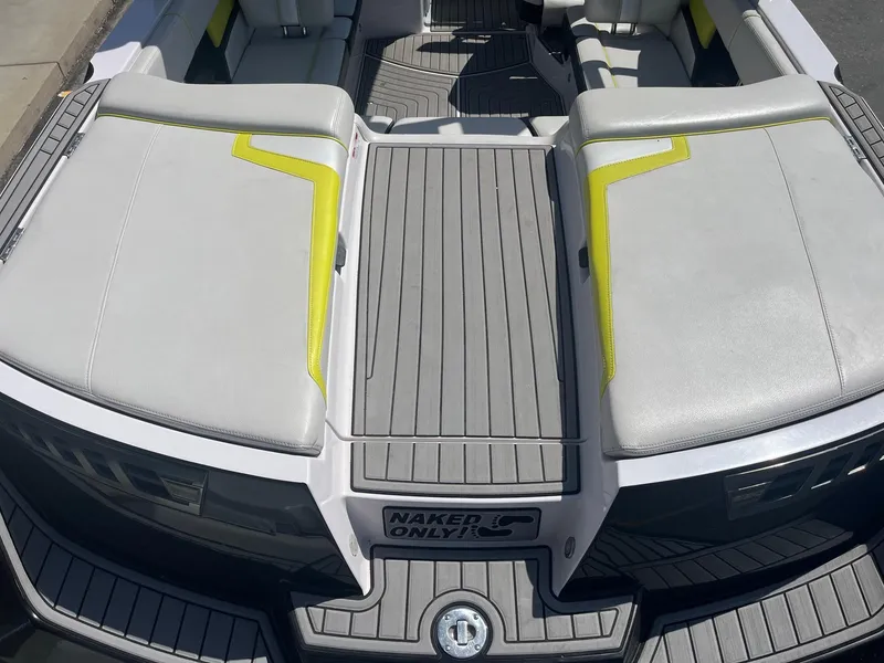 Slide: The Image of 2014 Nautique 230 TEAM EDITION boat interior with gray and yellow seating. - 16