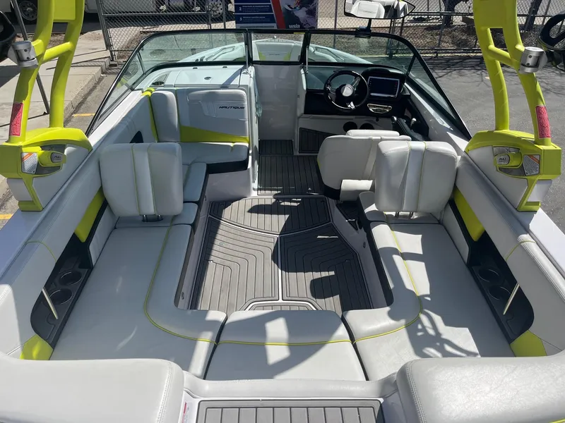 Slide: The Image of 2014 Nautique 230 TEAM EDITION boat interior with spacious seating and modern design. - 17