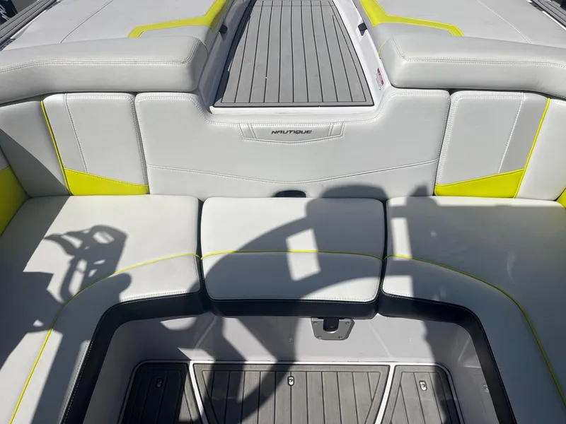 Slide: The Image of 2014 Nautique 230 TEAM EDITION boat interior with gray and yellow seating. - 21