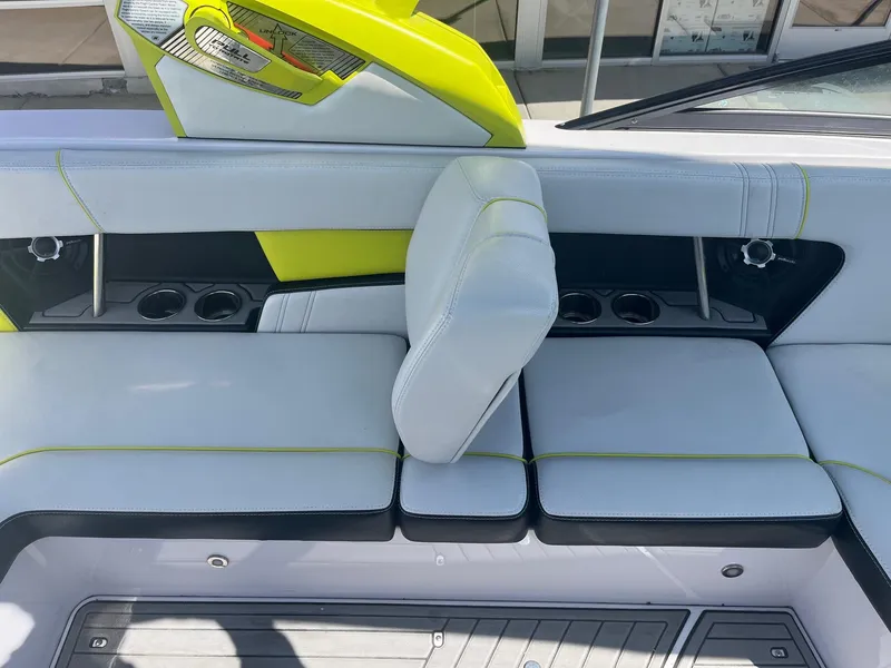 Slide: The Image of 2014 Nautique 230 TEAM EDITION boat interior with white and lime green seating. - 23