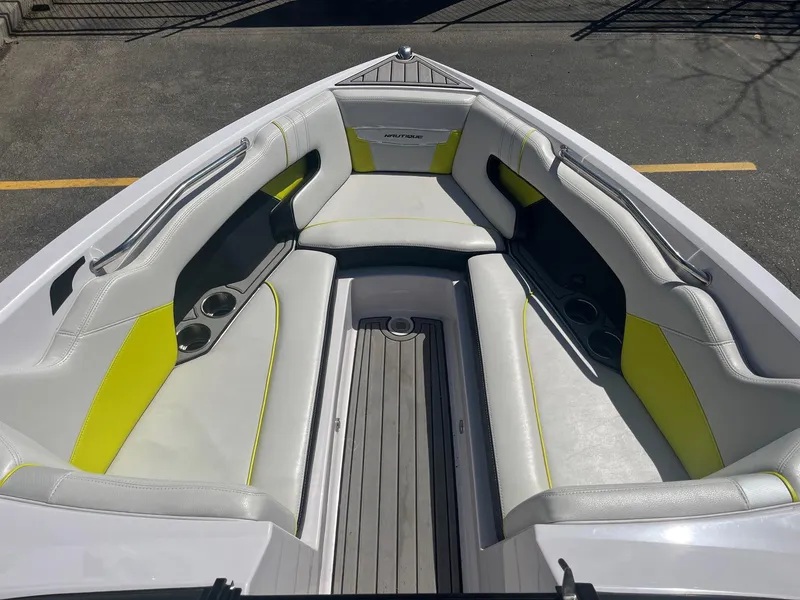 Slide: The Image of 2014 Nautique 230 Team Edition boat interior with white and yellow seating. - 29