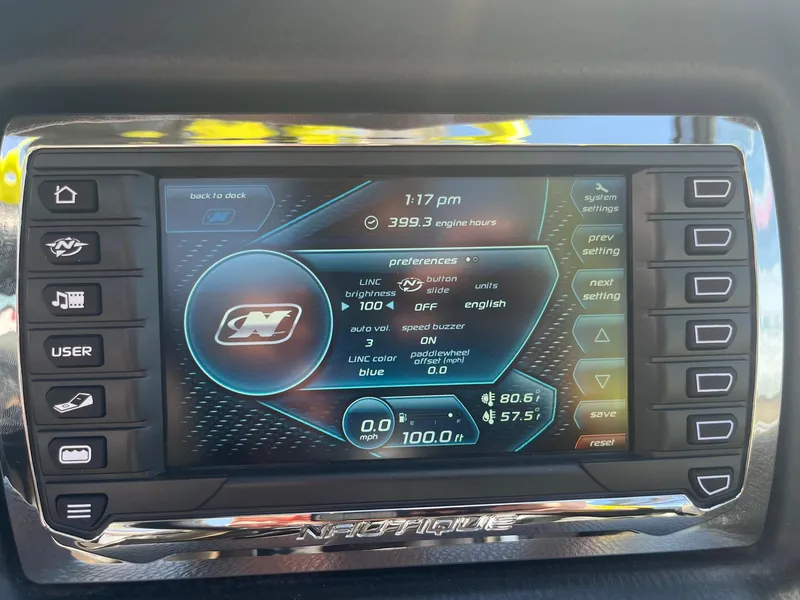 Slide: The Image of 2014 Nautique 230 TEAM EDITION dashboard display showing settings and engine hours. - 30