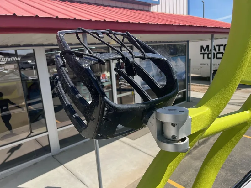 Slide: The Image of Wakeboard rack on 2014 Nautique 230 TEAM EDITION boat, near a building with red roof. - 32