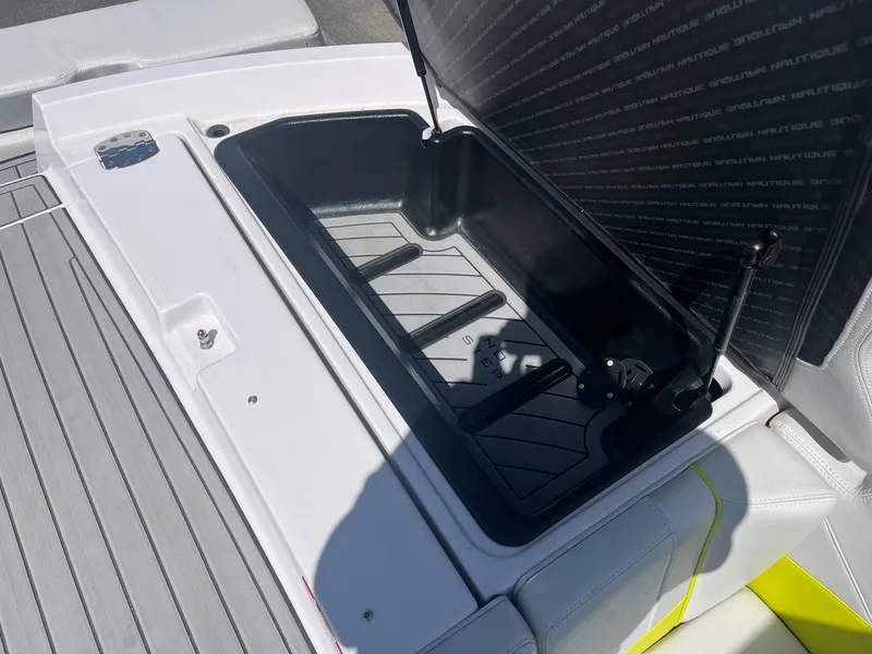 Slide: The Image of 2014 Nautique 230 TEAM EDITION boat storage compartment open on deck. - 34