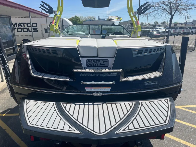 Slide: The Image of 2014 Nautique 230 TEAM EDITION boat, rear view, parked outdoors. - 6