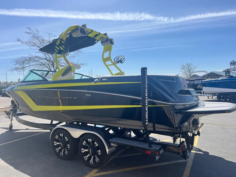 Slide: The Image of 2014 Nautique 230 TEAM EDITION boat on trailer, featuring sleek design and vibrant accents. - 7