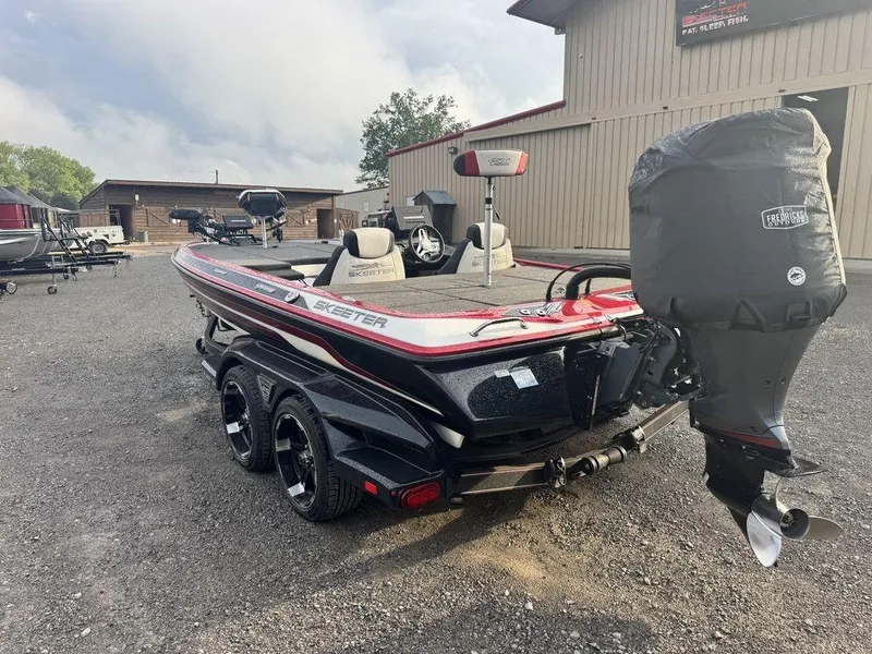 Slide: The Image of 2019 Skeeter FX20 LE boat with covered motor, parked outdoors near buildings. - 3