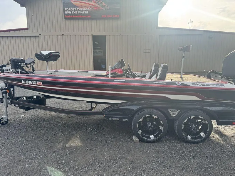 Slide: The Image of 2019 Skeeter FX20 LE boat on trailer, parked outside a building. - 4