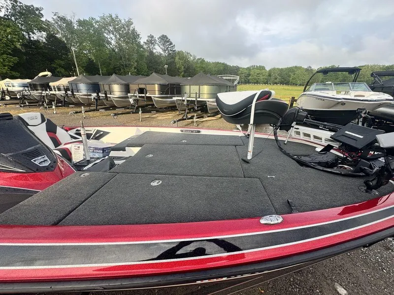 Slide: The Image of 2019 Skeeter FX20 LE bass boat with red trim, parked outdoors. - 8