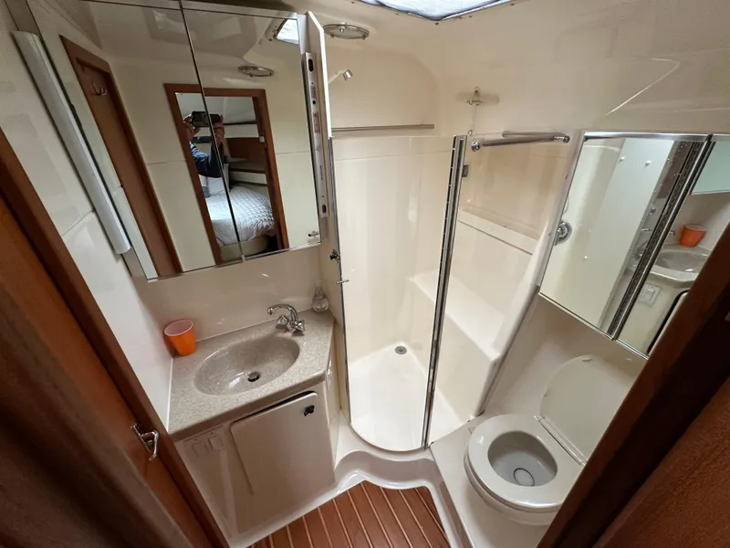 Slide: The Image of Bathroom interior of 1998 Tiara Yachts 4000 Express, featuring shower, sink, and toilet. - 17