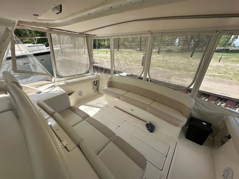 Slide: The Image of 1998 Tiara Yachts 4000 Express interior with beige seating and large windows. - 24