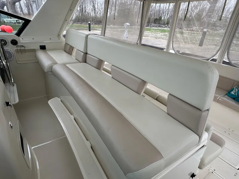 Slide: The Image of 1998 Tiara Yachts 4000 Express interior seating with beige and cream upholstery. - 25