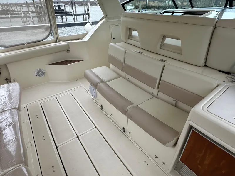 Slide: The Image of 1998 Tiara Yachts 4000 Express interior with beige seating and spacious layout. - 26