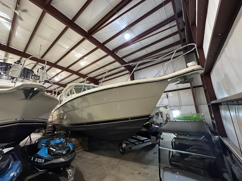 Slide: The Image of 1998 Tiara Yachts 4000 Express in storage, surrounded by other boats and equipment. - 28