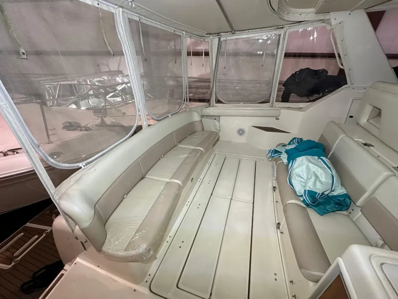 Slide: The Image of 1998 Tiara Yachts 4000 Express interior with beige seating and clear enclosures. - 31