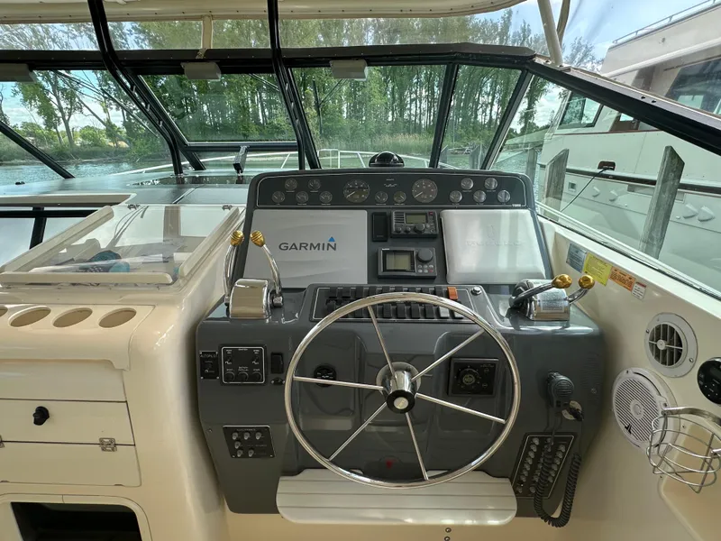 Slide: The Image of 1998 Tiara Yachts 4000 Express helm with Garmin navigation system and steering wheel. - 45