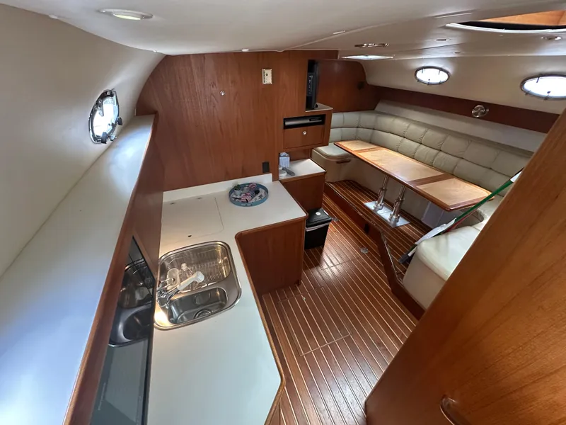 Slide: The Image of 1998 Tiara Yachts 4000 Express interior with kitchenette and seating area. - 46